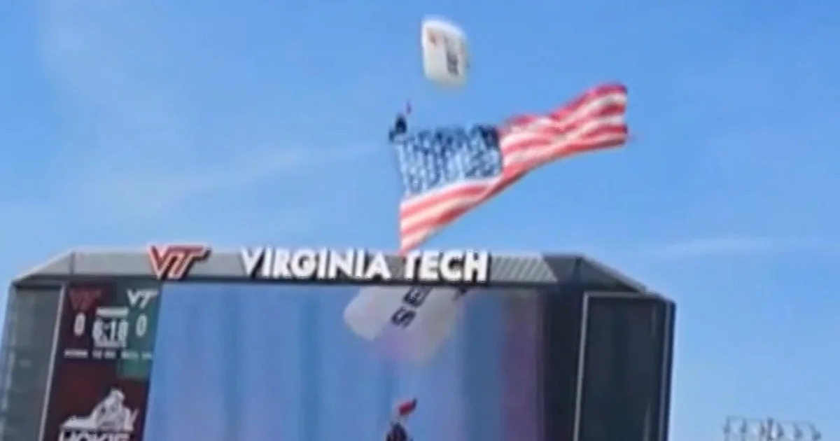Skydiver rescued after crashing into scoreboard during Virginia Tech football game